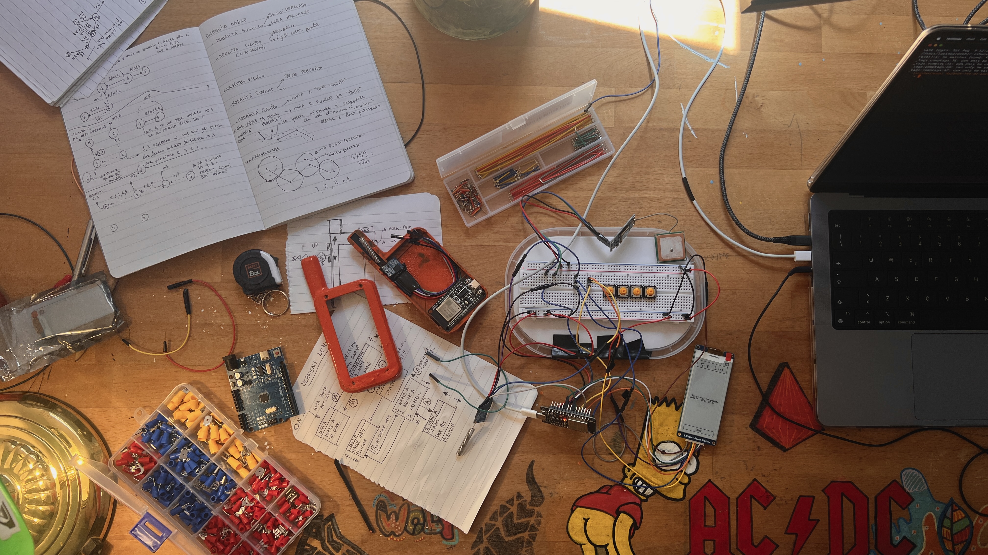The HEARD prototype on the workbench — breadboard, ESP32, GPS, e-ink display and hand-drawn protocol notes